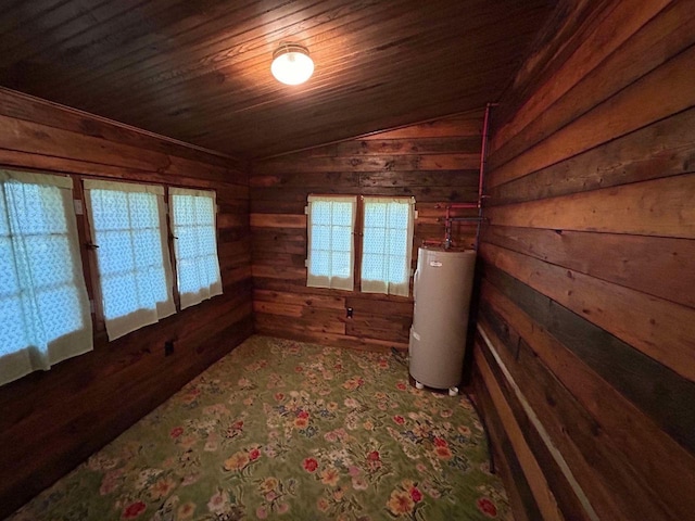 interior space with wooden ceiling, water heater, lofted ceiling, and wood walls