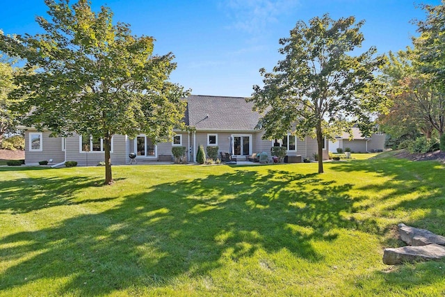 rear view of property featuring a yard