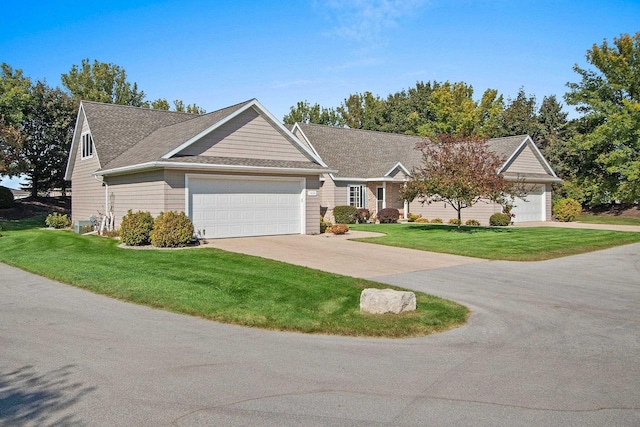 ranch-style house with a garage and a front yard