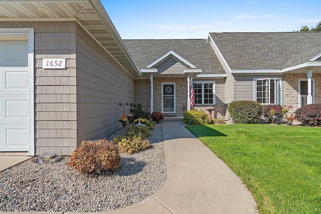 entrance to property featuring a lawn