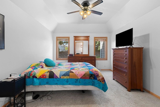 bedroom with vaulted ceiling, ceiling fan, and light colored carpet