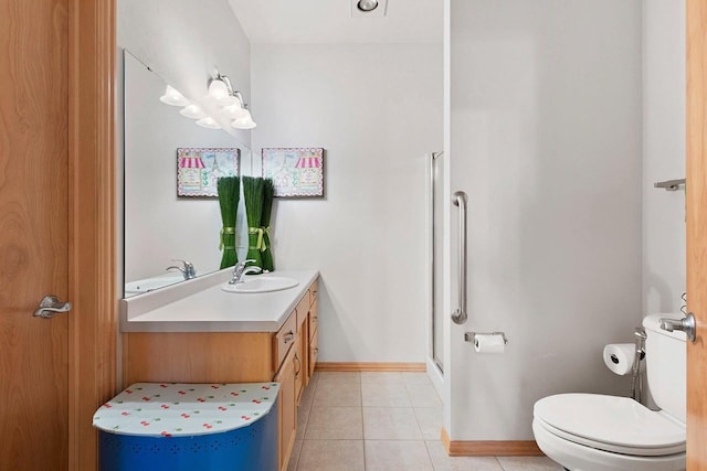 bathroom featuring tile patterned floors, walk in shower, vanity, and toilet