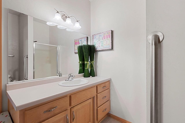 bathroom featuring walk in shower, vanity, and toilet