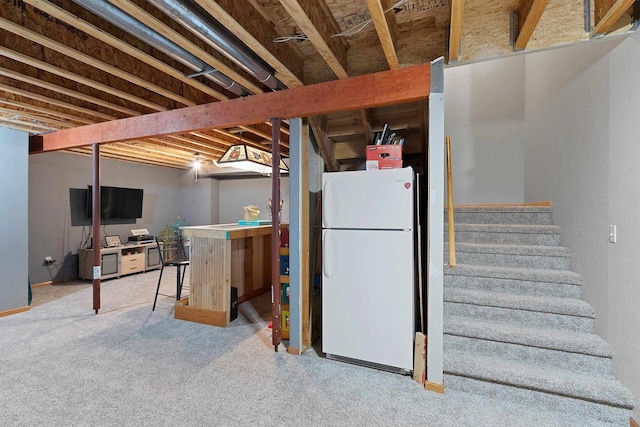 basement with carpet flooring and white fridge