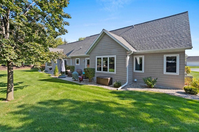 back of property featuring a lawn and a patio area