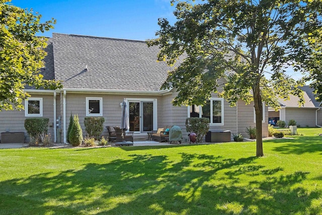 rear view of property featuring a yard and a patio area