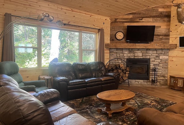 living room featuring wooden walls, lofted ceiling, hardwood / wood-style floors, and a wood stove