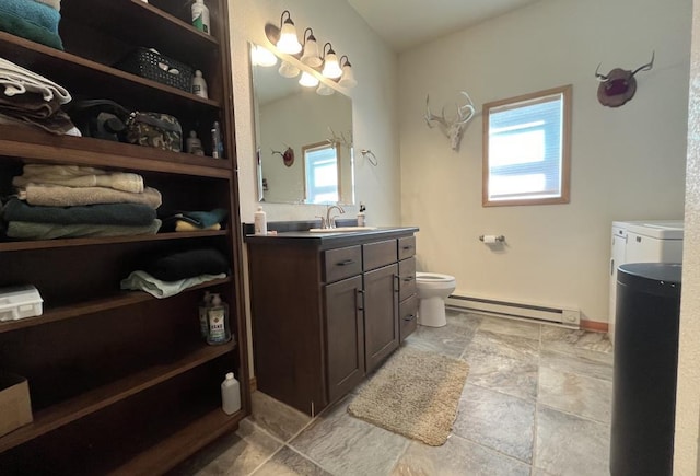 bathroom featuring a healthy amount of sunlight, vanity, toilet, and a baseboard radiator