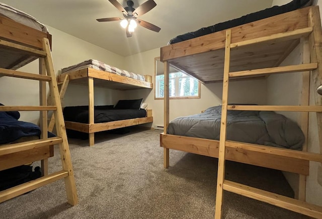 bedroom with carpet flooring, vaulted ceiling, baseboard heating, and ceiling fan