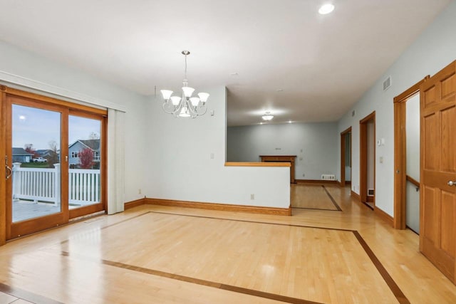 empty room featuring an inviting chandelier