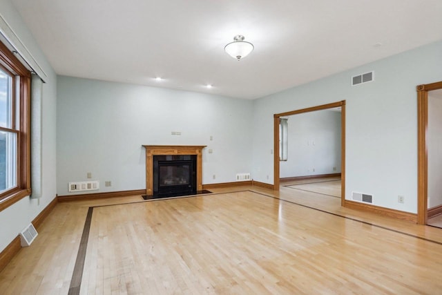 unfurnished living room featuring light wood-type flooring