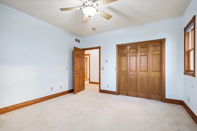 unfurnished bedroom featuring ceiling fan and light colored carpet