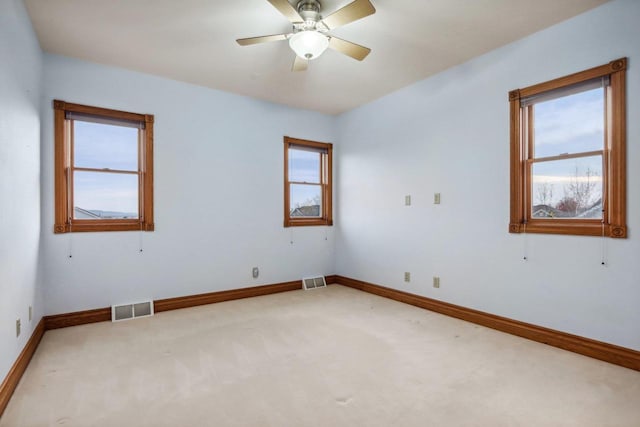 empty room with carpet flooring and ceiling fan