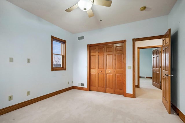 unfurnished bedroom featuring light colored carpet and ceiling fan