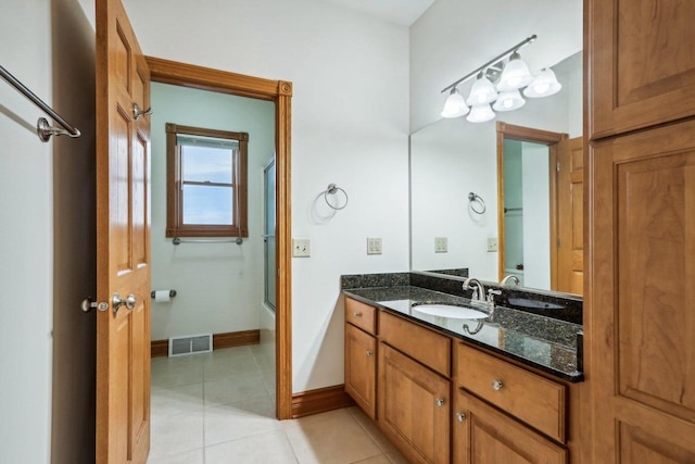 bathroom with shower / bath combination with glass door, tile patterned flooring, and vanity