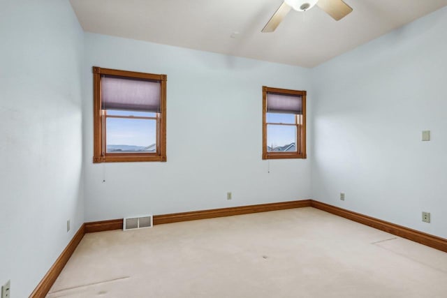 empty room featuring carpet flooring and ceiling fan