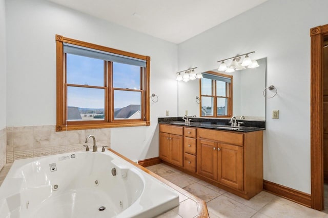 bathroom with tile patterned floors, tiled tub, and vanity