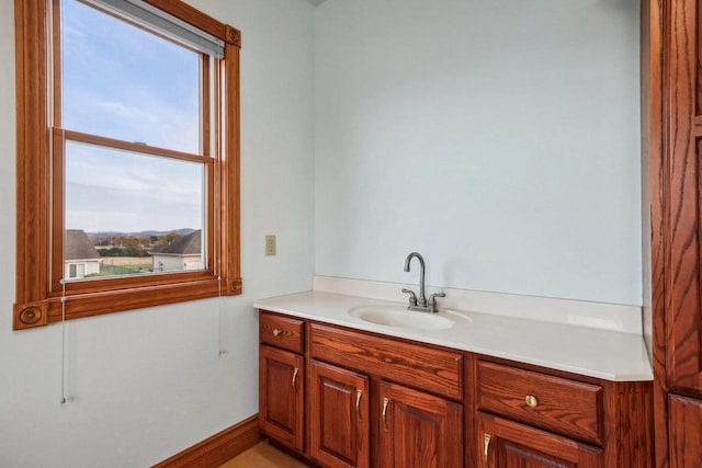 bathroom with a wealth of natural light, vanity, and a mountain view