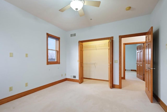 unfurnished bedroom with ceiling fan, light colored carpet, and a closet