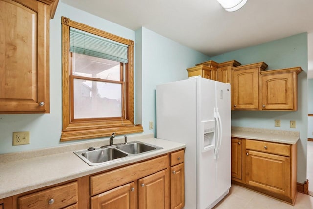 kitchen featuring sink and white fridge with ice dispenser