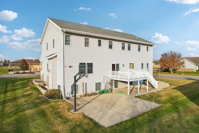 back of property featuring a lawn and a deck