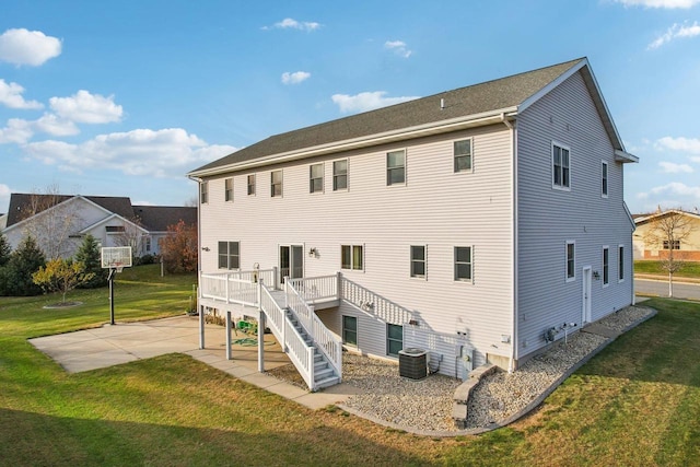 back of property with a yard, cooling unit, a patio area, and a wooden deck