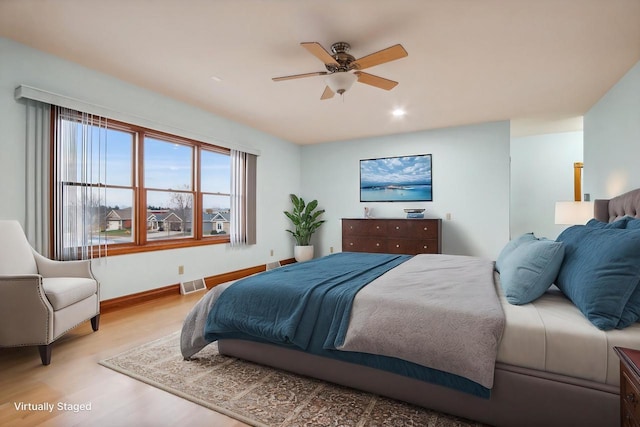 bedroom featuring light hardwood / wood-style flooring and ceiling fan