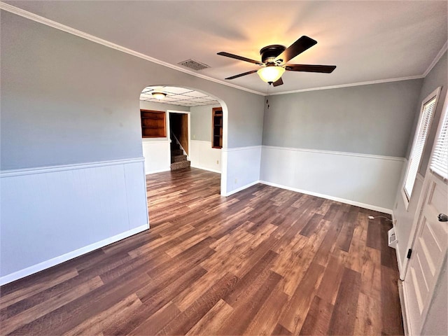 spare room featuring ornamental molding, ceiling fan, and dark wood-type flooring