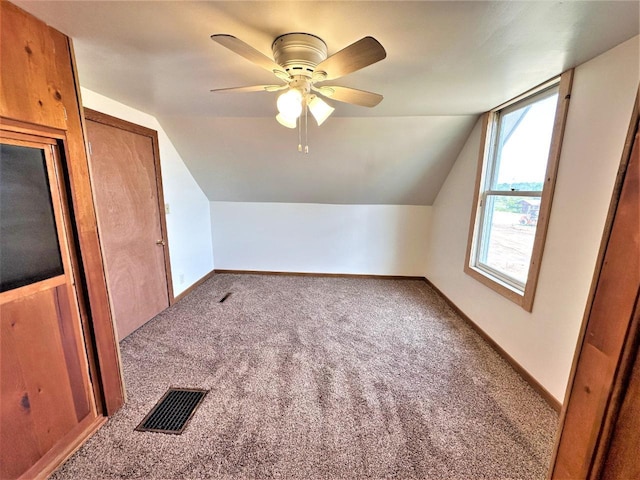 additional living space featuring lofted ceiling, carpet flooring, and ceiling fan