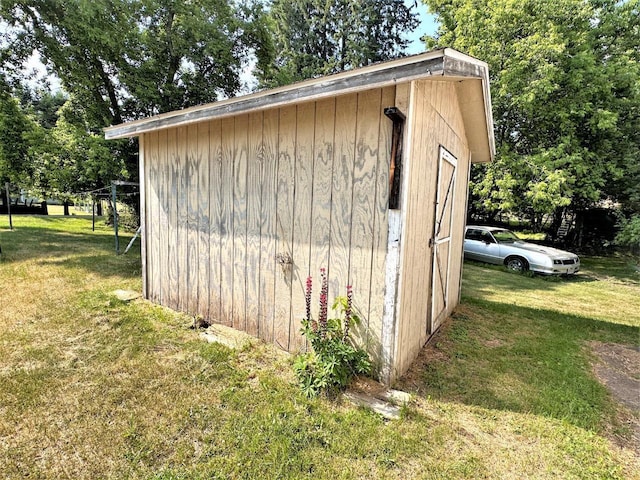 view of outdoor structure featuring a lawn