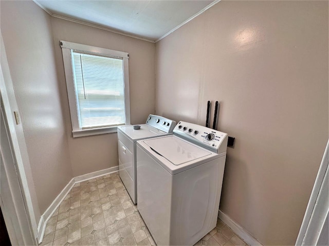 washroom featuring washer and clothes dryer and crown molding