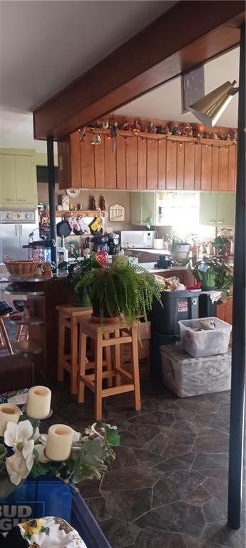 kitchen with beam ceiling and white fridge