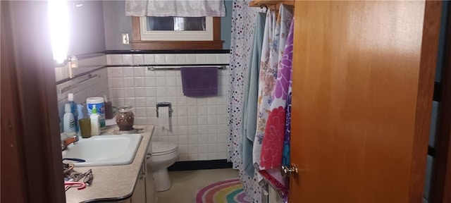 bathroom featuring vanity, toilet, tile walls, and a shower with shower curtain