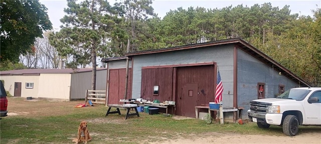 view of outbuilding featuring a yard