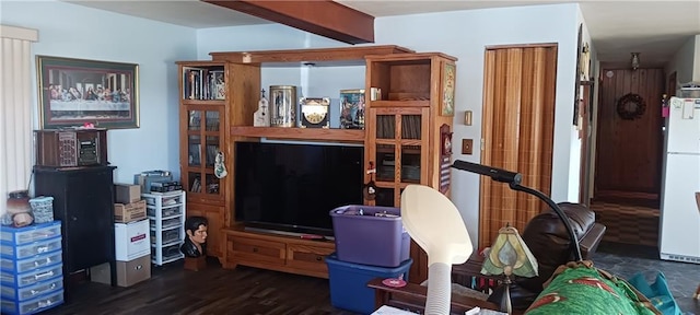 living room featuring beamed ceiling and dark hardwood / wood-style flooring