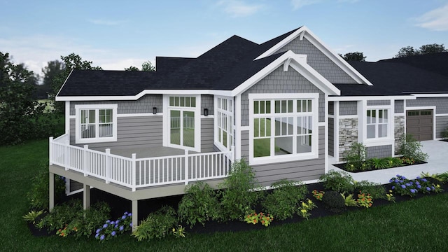 rear view of property with a wooden deck, a lawn, and a garage