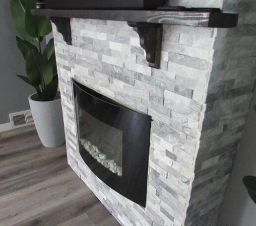 room details with hardwood / wood-style flooring and a fireplace