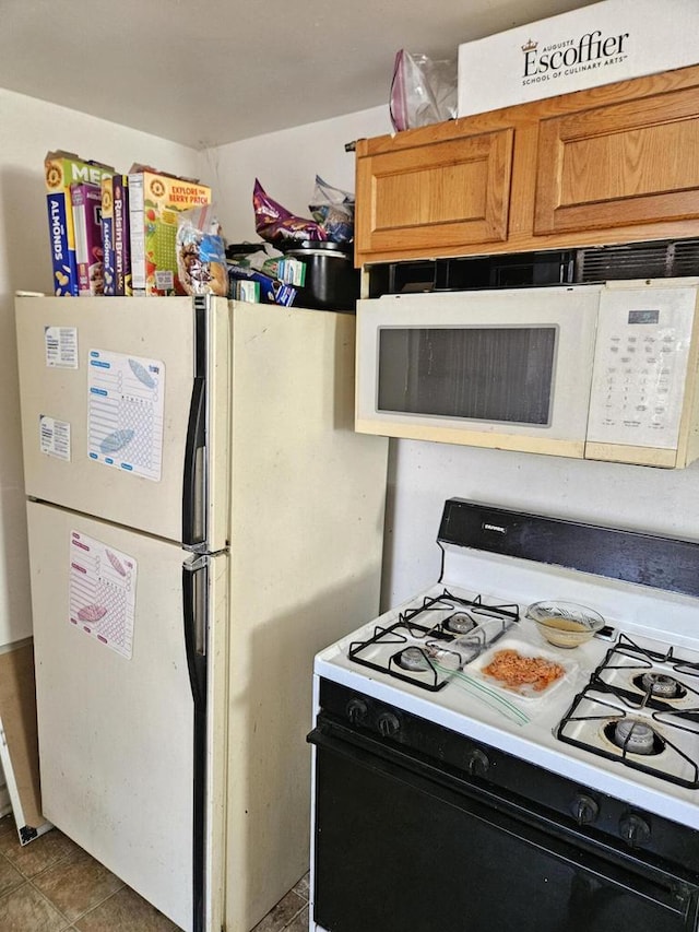 kitchen featuring white appliances and tile patterned floors