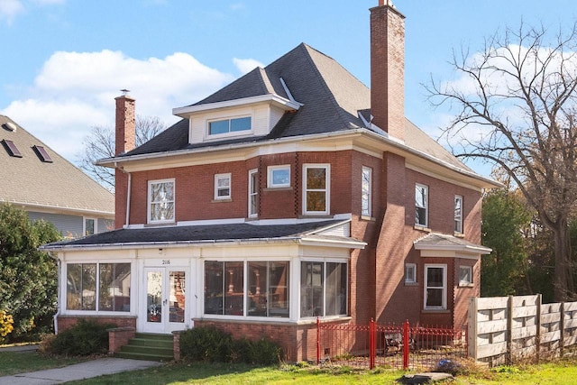 back of property featuring a sunroom