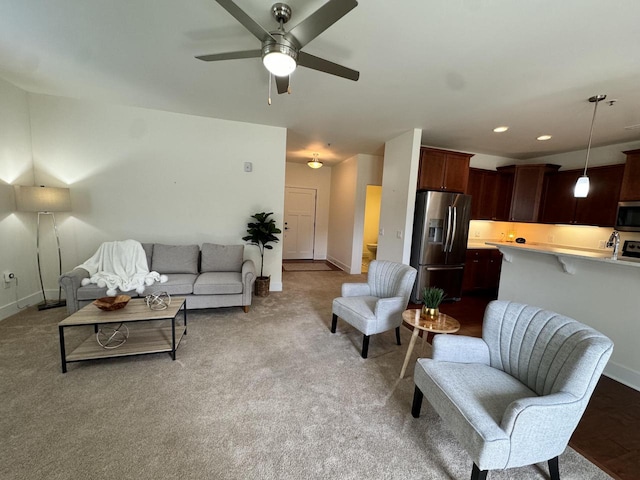 living room with ceiling fan and light carpet