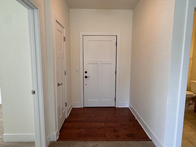 hall with dark wood-type flooring