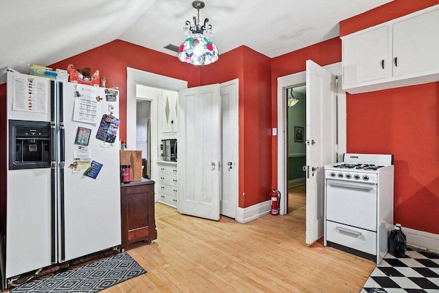 kitchen with white cabinetry, vaulted ceiling, white appliances, light hardwood / wood-style flooring, and decorative light fixtures