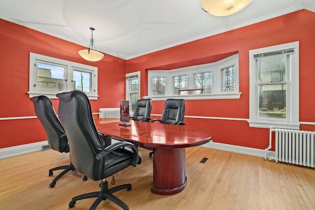 home office featuring radiator heating unit, light hardwood / wood-style floors, and ornamental molding