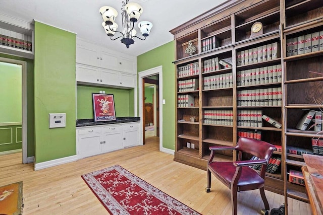 sitting room with a chandelier and light hardwood / wood-style floors