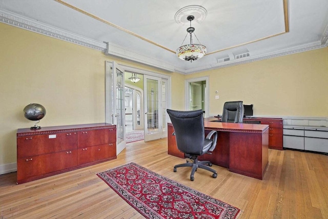 office space featuring light wood-type flooring, crown molding, and french doors