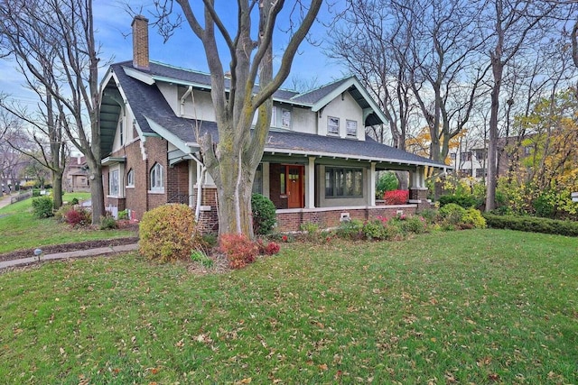 view of front of property featuring covered porch and a front yard