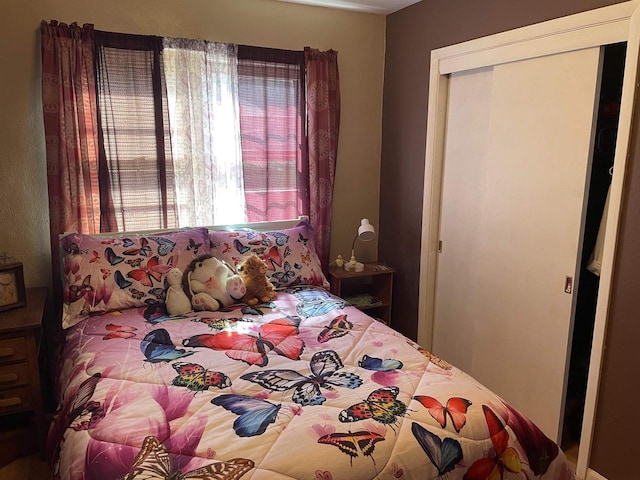 bedroom featuring multiple windows and a closet