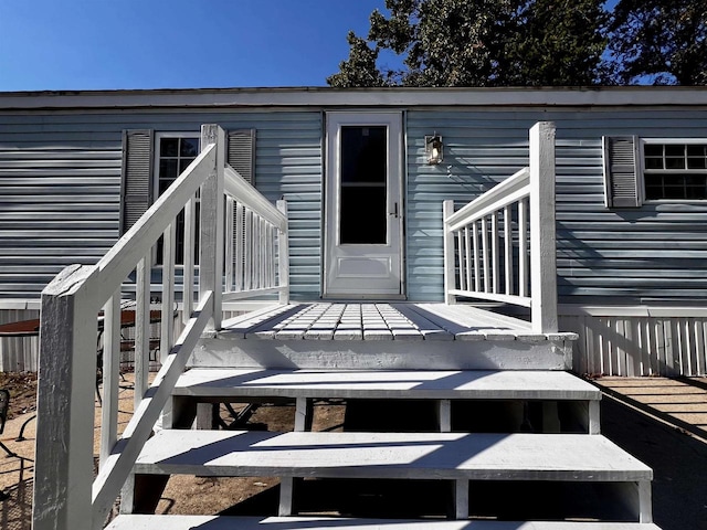 entrance to property featuring a wooden deck