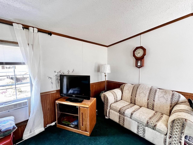 living room with wood walls, a textured ceiling, crown molding, and dark colored carpet