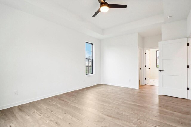 empty room with light wood-type flooring and ceiling fan